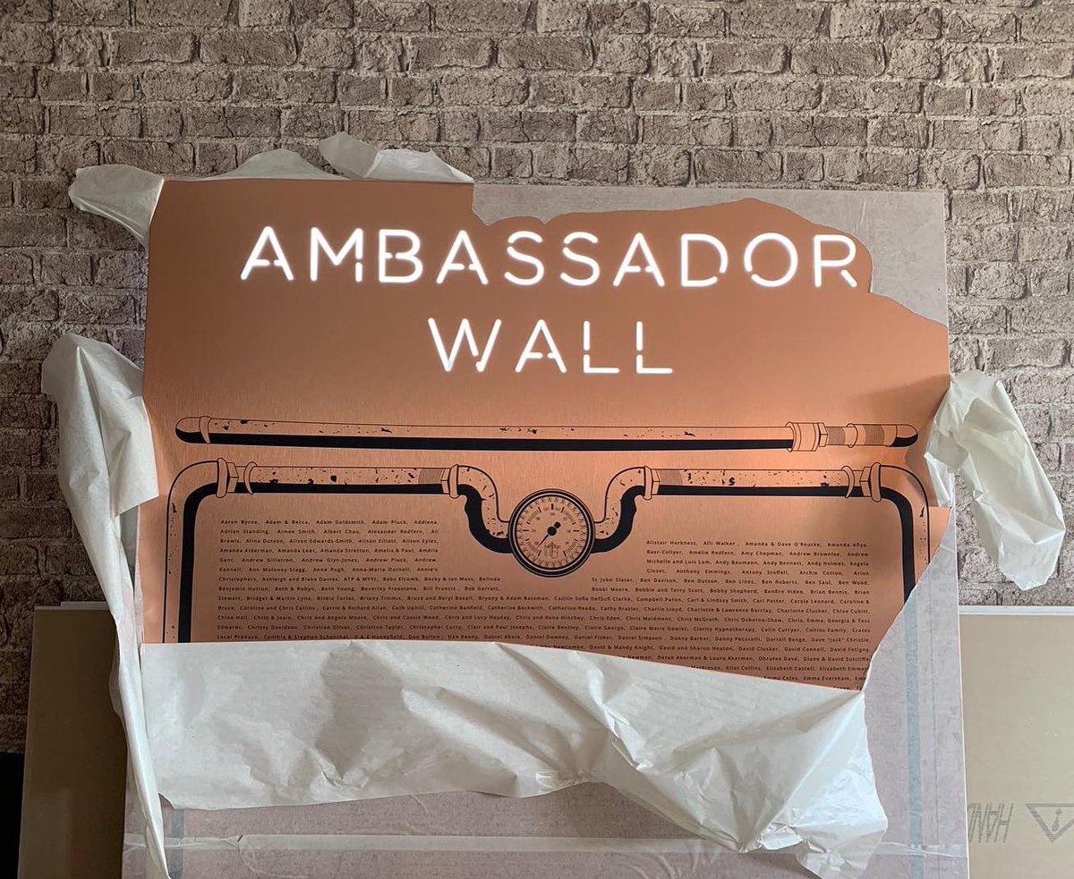Wearehype's tweet photo. And here it is 🥁... The Heritage Ambassador Wall, featuring a custom steam punk inspired design and integrated lighting. It was so much fun to design this and we wish @MattGillan every success with the Heritage opening! Can you spot your name? 👀 https://t.co/W8kKJrWSvM