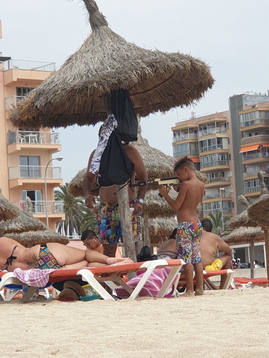 How retarded parents can be, letting their child playing like a childsoldier with a authentic looking toygun with shooting sound at a full beach in 2019. #shame #mallorca #playadepalma #platjadepalma #retarded