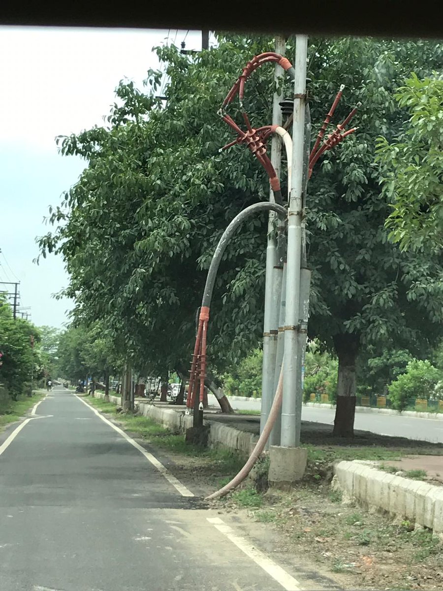 Rwa93b's tweet photo. Condition of service road Sector- 93B... the poles, open wires and manholes are a major hinderance.@noida_authority https://t.co/rwW6bl7ZSa
