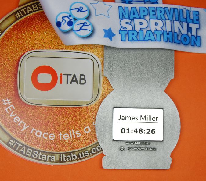 iTABTeam's tweet photo. The personalized #iTABs look awesome in the back of the @NapervilleTri finisher medals! If you ordered an iTAB in reg, it'll be with you in around 7-10 working days. Why not celebrate your achievement with an iTAB? - https://t.co/oABJoCsz0k #NapervilleTri #everytritellsastory https://t.co/y5Yxr5U7Jv