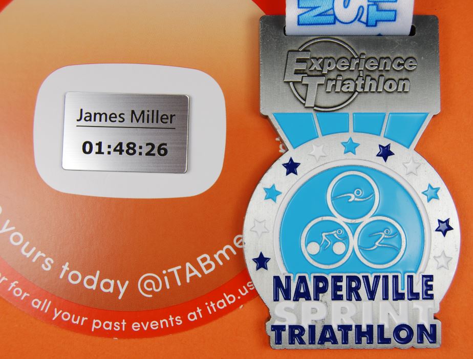 iTABTeam's tweet photo. The personalized #iTABs look awesome in the back of the @NapervilleTri finisher medals! If you ordered an iTAB in reg, it'll be with you in around 7-10 working days. Why not celebrate your achievement with an iTAB? - https://t.co/oABJoCsz0k #NapervilleTri #everytritellsastory https://t.co/y5Yxr5U7Jv