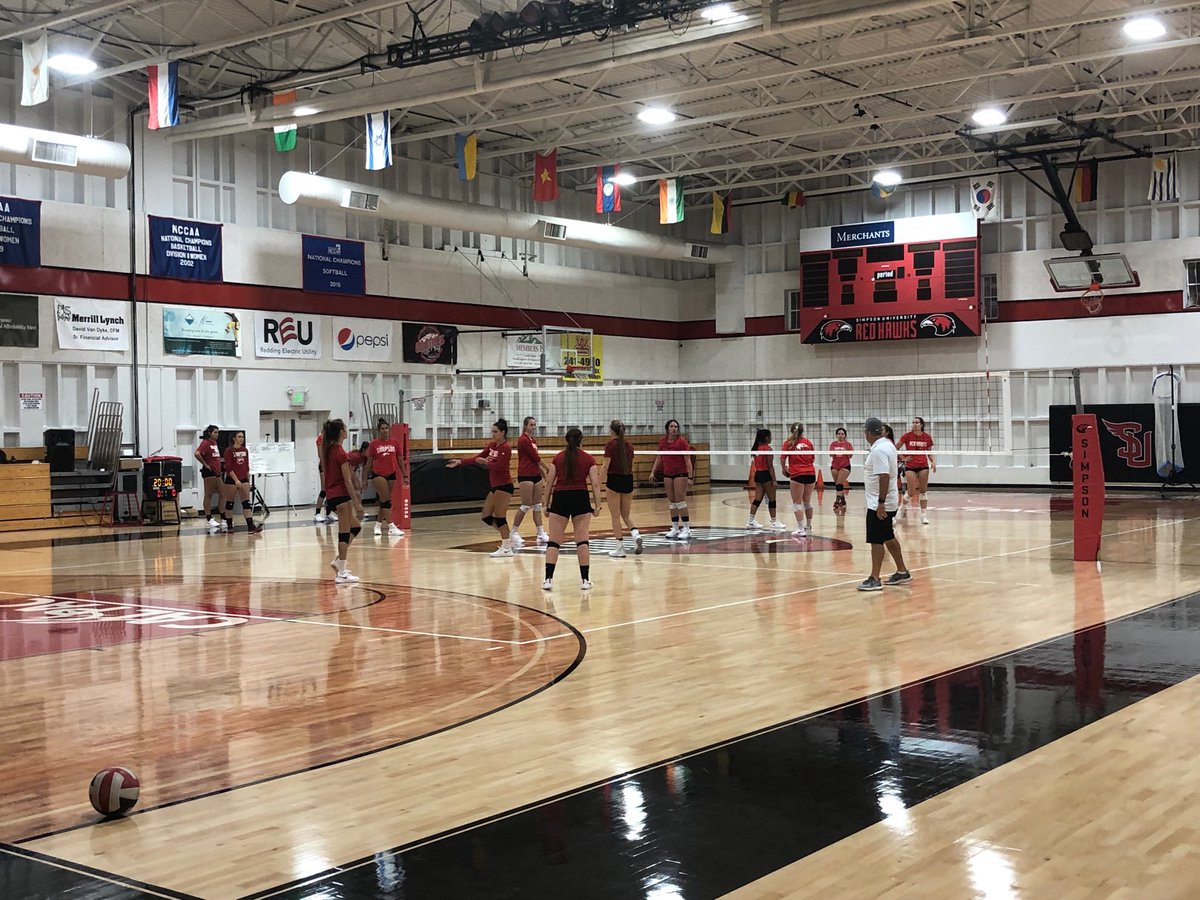 SimpsonRedHawks's tweet photo. A whole bunch of NEW in this photo of ⁦@SimpsonUVB⁩ — new coach, Mike Haworth ⁦⁦@volleyworth⁩ — new floor — new scoreboard — new season. It’s a great day to be a Simpson Red Hawk. #SimpsonRising https://t.co/DqsSCAjYPp