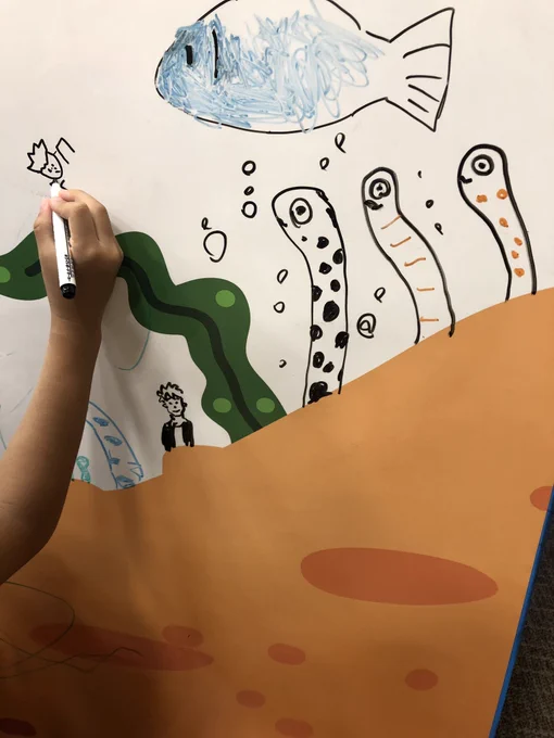 水族館に落書きコーナーがあったので、子どもとチンアナゴを描いたよ。それを覗く赤松くんも描いたよ。 