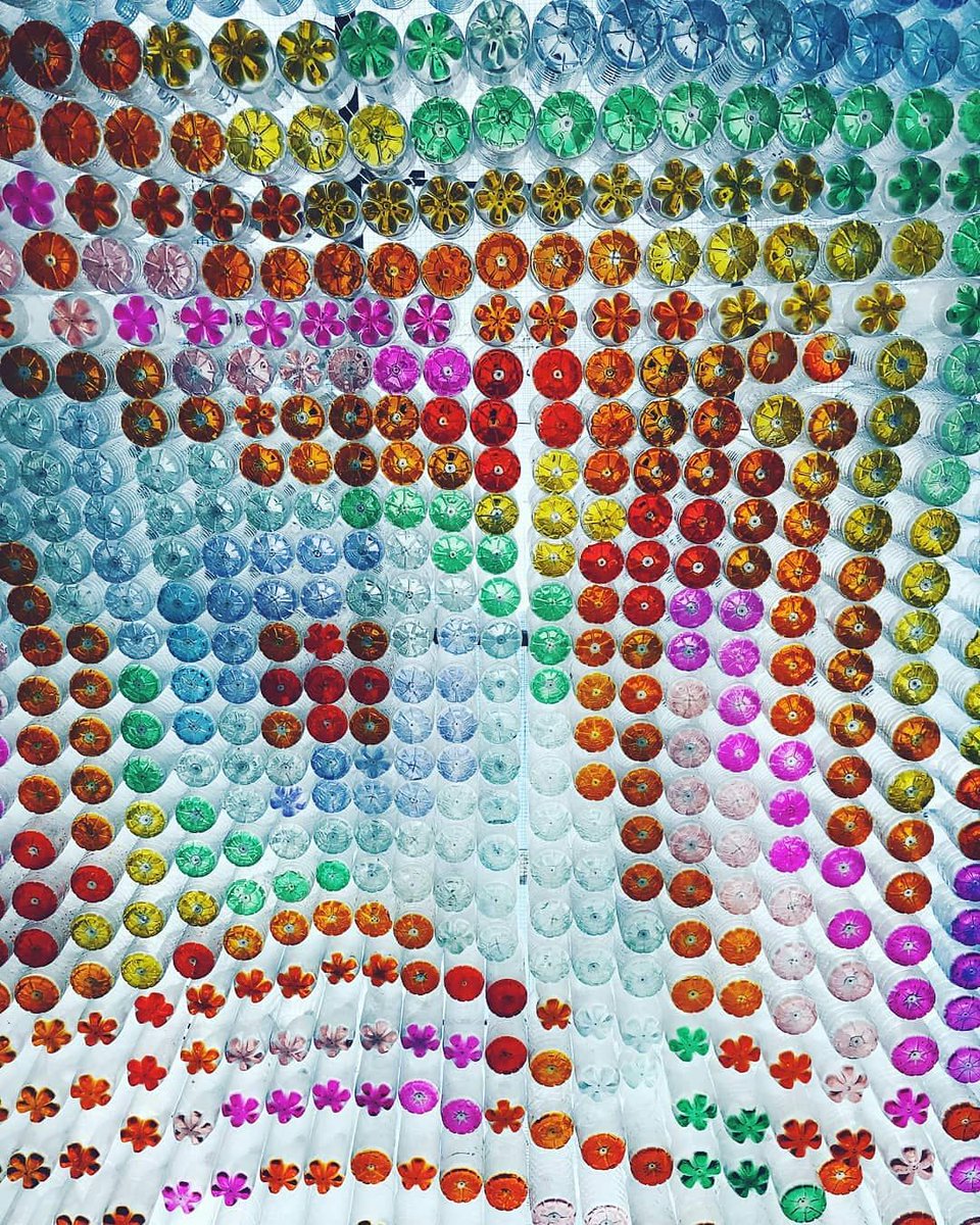 BlackFemArc's tweet photo. 1,600 plastic bottles formed a wavy canopy projecting sunlight through coloured water to create an incredible multi-coloured mosaic mural @BrainchildFest. Who created this might you ask? Our incredible BFA committee member Seyi Adele and we're in absolute love 💕 https://t.co/6GSfy8UX1z