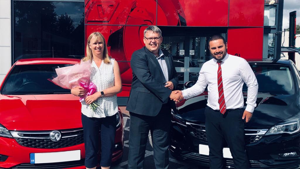 vauxhall's tweet photo. Mr Taylor collected his 20th #Vauxhall yesterday!  Danny Evans from @BellingerVaux handed over the keys to an Astra 1.4 Turbo Elite Nav, and flowers to Mrs Taylor. https://t.co/GDW1dUeXez