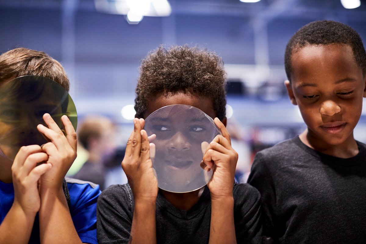 Wolfspeed's tweet image. More than 100 kids from @WakeBGC and more than 200 employees and their children are taking part in the fun by experimenting with LEDs, robotics, building bottle rockets and air cannons, racing with engineers and more. #PoweringOurCommunity #STEM