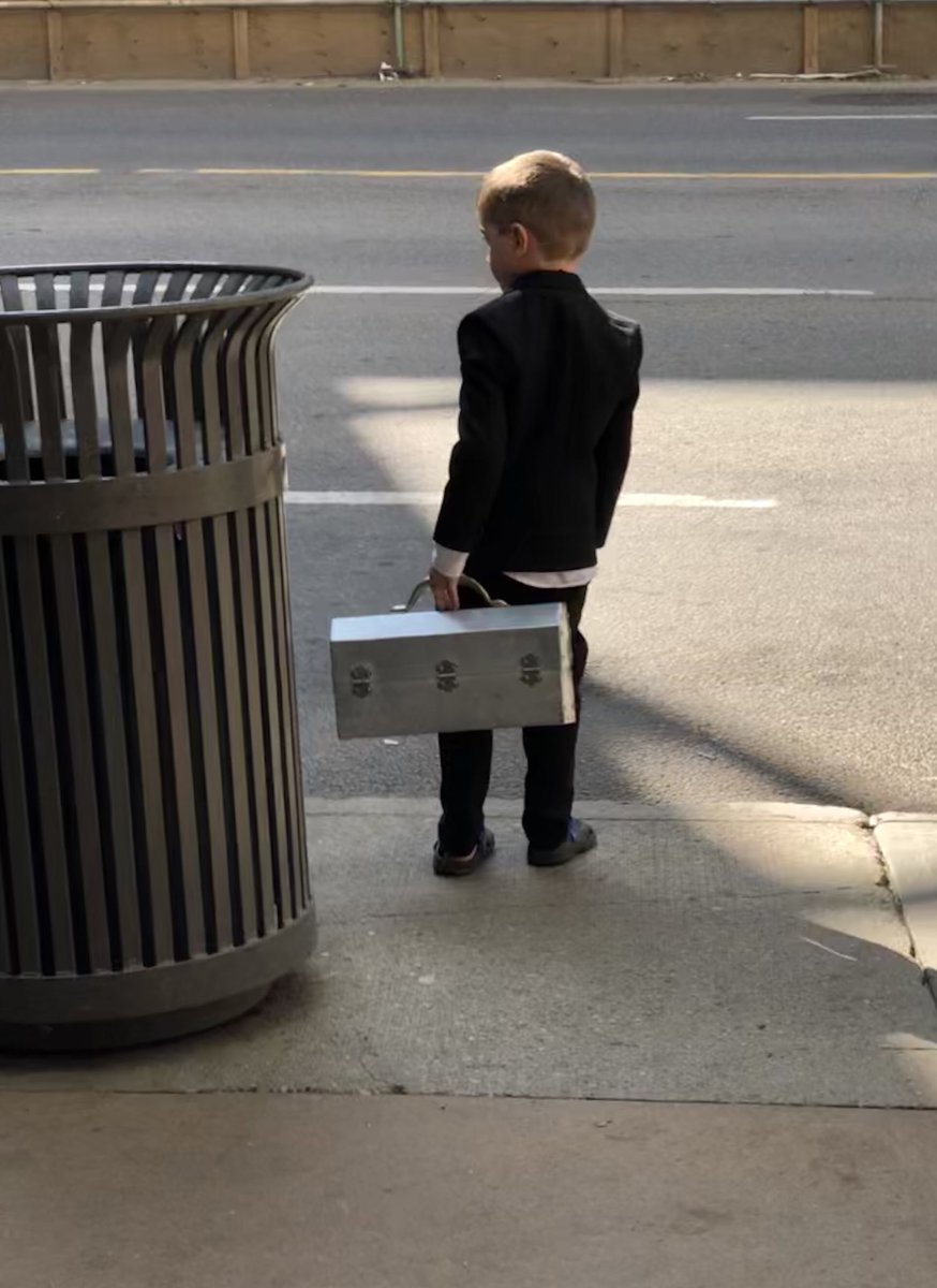 This kid, waiting for the bus in a suit, tie and crocs, with amazing lunchkit wins the day. #friday #work
