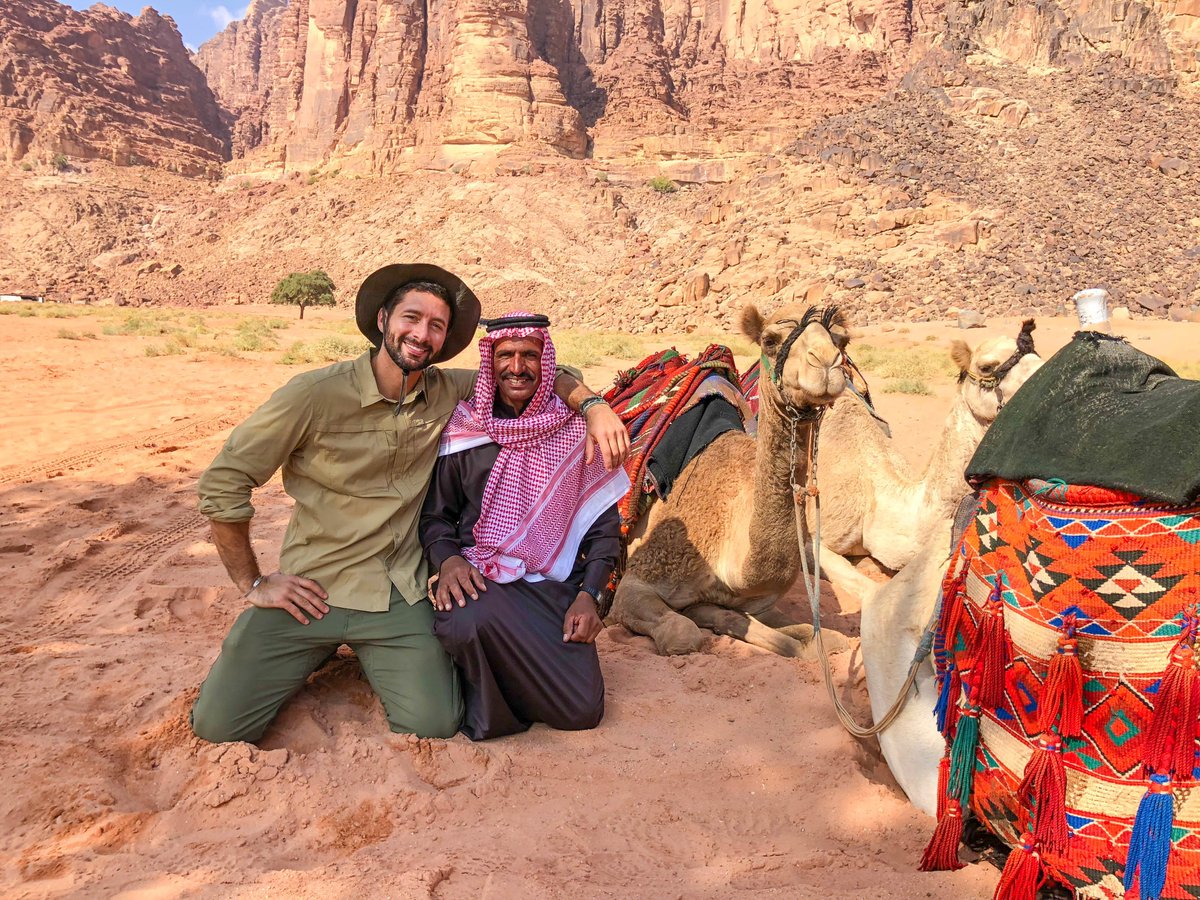 NBCTheVoyager's tweet photo. Docked in Aqaba, @mrjoshuagarcia joins a Bedouin tribe member &amp; explores Wadi Rum, a protected desert wilderness of red sand dunes &amp; granite rock formations! #TheVoyager https://t.co/JWqnJa3rWa