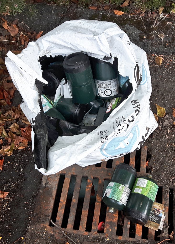 Robot111695's tweet photo. Big plastic bag full of old propane tanks dumped at the vacant end of a parking lot. Who accumulates this many propane tanks?? 
#PropanePropane
#GottaLightTheFlame
#RecycleThatShit https://t.co/FcRbUaLFjg