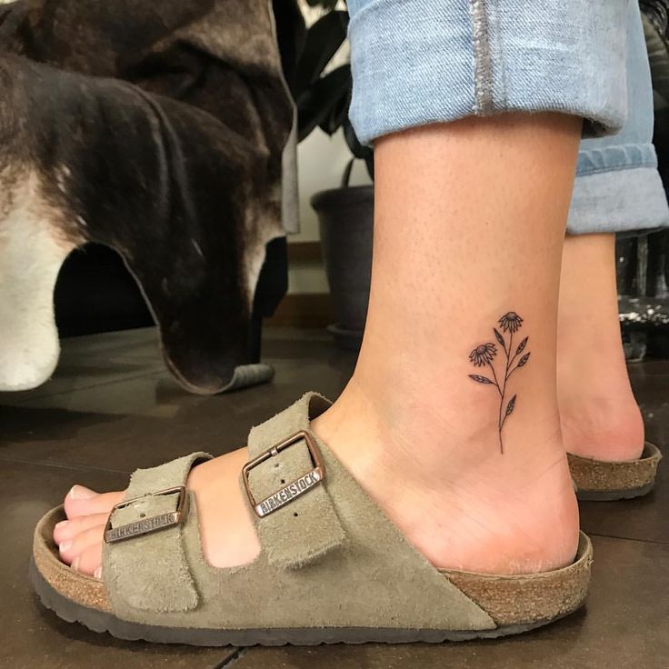 Premium Photo | There is a woman with a tattoo on her leg that has flowers  on it generative ai