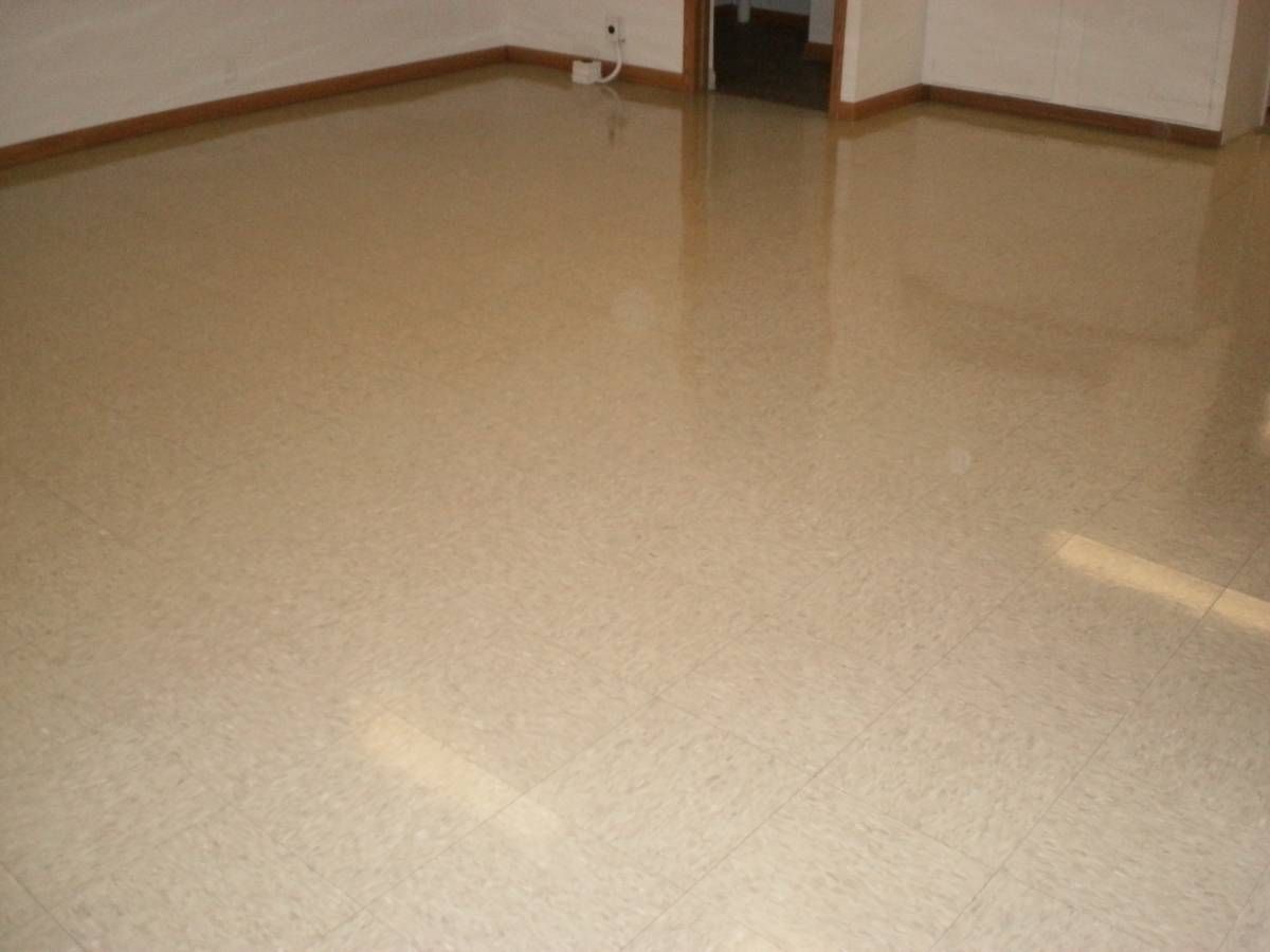 A photograph of a waxed linoleum tile floor.