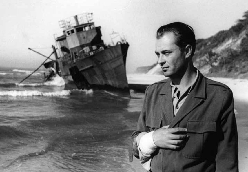 Came across this photo of everyone's favorite 1950s Polish filmstar, Jerzy Pietraszkiewicz, on the set of Uczta Baltazara.

In the back, a minesweeper wrecked on a Polish beach. 

Sharing this for no other reason than its sensational dieselpunk esthetics.