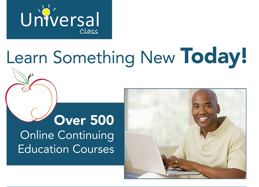 a photgraph of a black man smiling looking straight ahead sitting next to a laptop