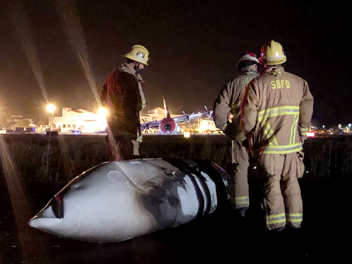 EliasonMike's tweet photo. #AircraftEmergency- A Private C-130 aircraft (background) made an emergency landing, crashed and caught fire at the Santa Barbara Airport at 10:13 p.m. Sunday.  7 souls aboard/escaped w no injuries. **ALL MEDIA CALL SBAirport PIO At 805-319-1400** https://t.co/KYZ0E8oFlM