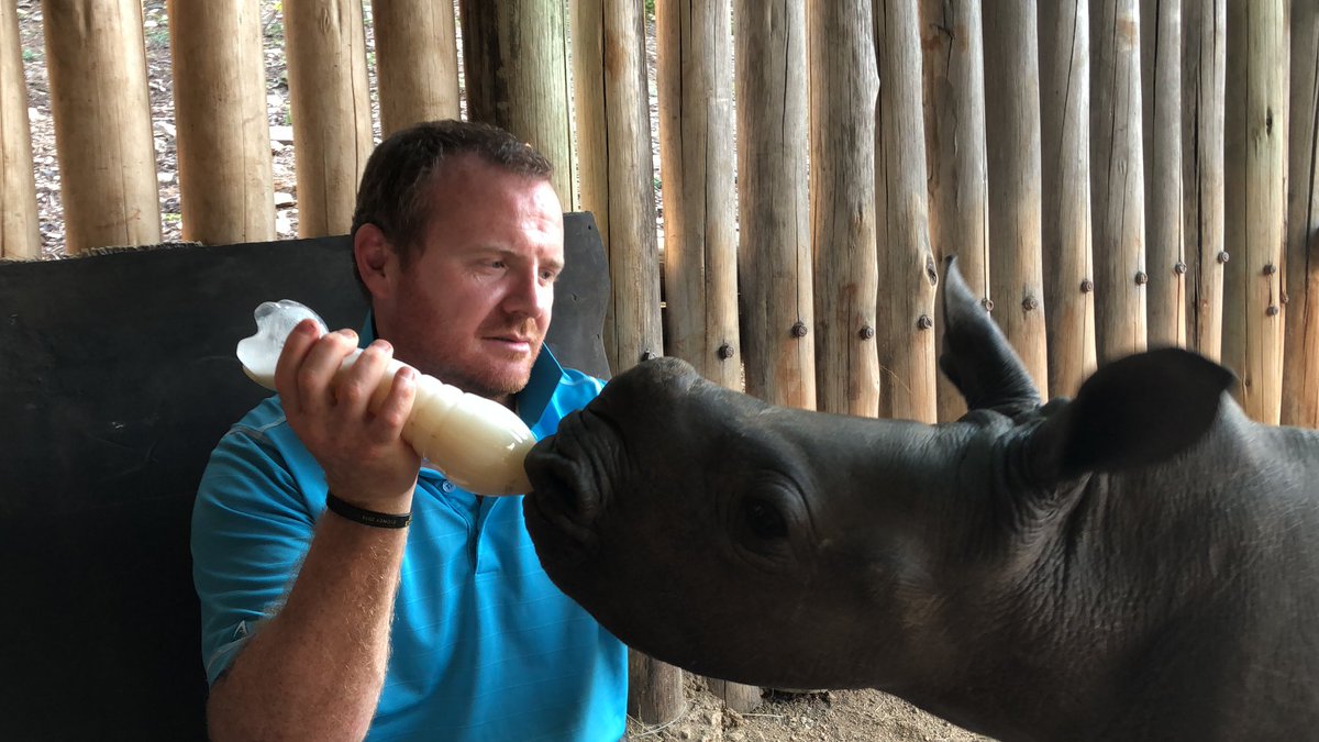 Blesma's tweet photo. A former Royal Marine who lost both his legs serving in Afghanistan has been spending time with baby rhinos in South Africa in a unique project that helps veterans who suffer from PTSD. https://t.co/SPqq9io13D