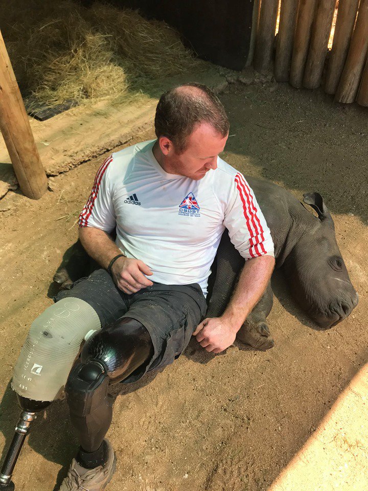 Blesma's tweet photo. A former Royal Marine who lost both his legs serving in Afghanistan has been spending time with baby rhinos in South Africa in a unique project that helps veterans who suffer from PTSD. https://t.co/SPqq9io13D