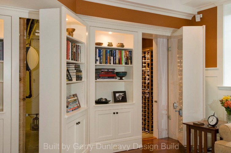 Custom lit #bookcases conceal the #mechanical room and #wine cellar.