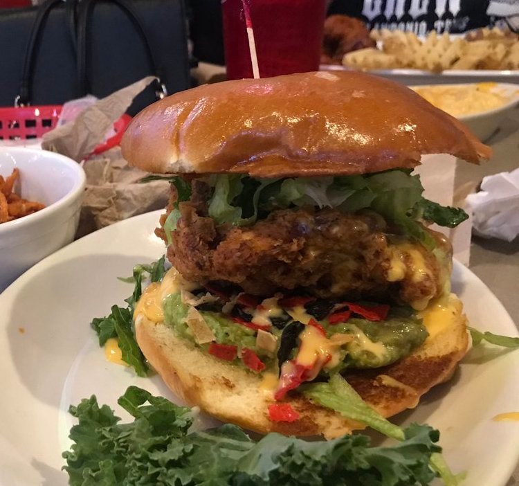 Pluckers's tweet photo. CHEECH AND CHONG: a fried chicken breast sandwich smothered with queso, guacamole, grilled onions, and tortilla chips. https://t.co/Jp3MB7F8cC