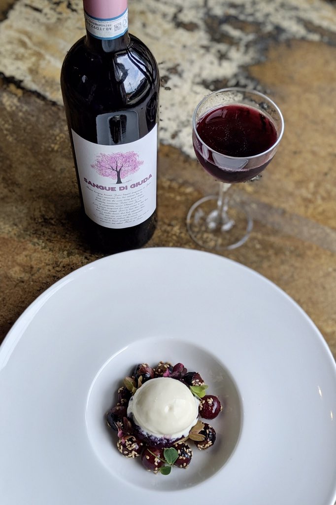 Introducing our #new dessert: grape, plated with goat cheese, benne, and brioche. We recommend pairing it with a glass of <a href="/calatronivini/">Calatroni Vini</a>, “Sangue di Giuda,” a semi-sweet wine from Lombardy, Italy with aromas and flavors of grape jam and purple flower! #dessert #eatdrinkclt