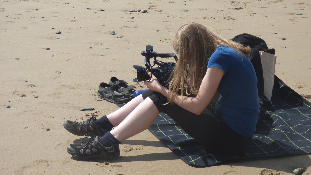 Here I am hiding behind my hair and my camera shooting some GVs for the doc in Pembrokeshire #filming #beach