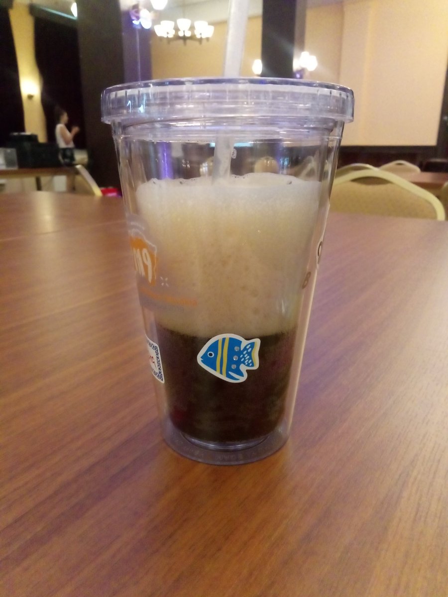 Reusable plastic mug with a fish sticker.