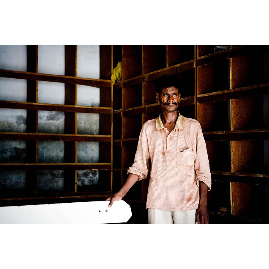 Amongst the intricate chaos of life in Delhi, the Hindu temple provides a rare oasis of calm. The gentleman places the visitor's shoe’s cubbies in wooden cubbies for safekeeping.
