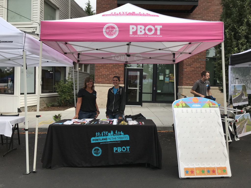 PBOTinfo's tweet photo. We’re so excited to celebrate #MultnomahDays with you, #Portland! PBOT staff will be at our tables and available to chat from now until 5 pm. Grab a #FixingOurStreets hat for your kiddo or play plinko with friends. We’ve got great swag to share! #ilovemultnomahvillage https://t.co/zcOv8oozEv