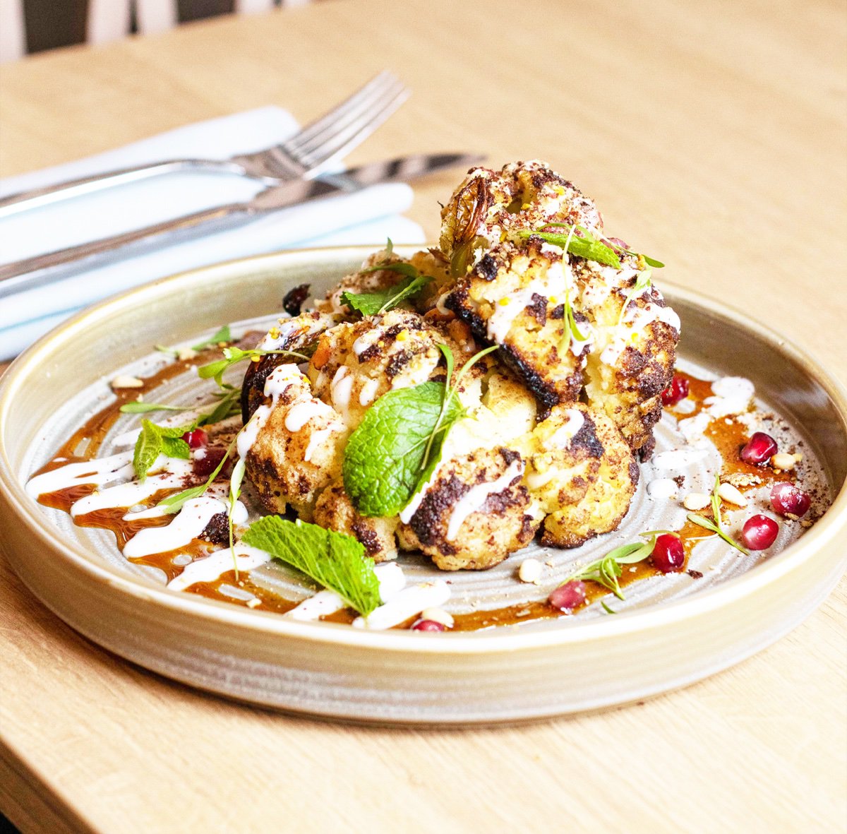 Love going out for Sunday dinner but struggle to find a vegan option? We serve our Plannt roast cauliflower shawarma with coconut yoghurt, pine nuts, pomegrante and rose. Served from 2pm every Sunday. Thanks for the pic! @foodshak #wearefoodwell #sundaylunch #vegan 
#manchester