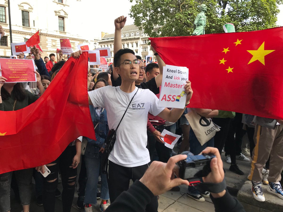 Pro-CCP Chinese nationalists hurling abuse at the Hong Kong rally in London yesterday.