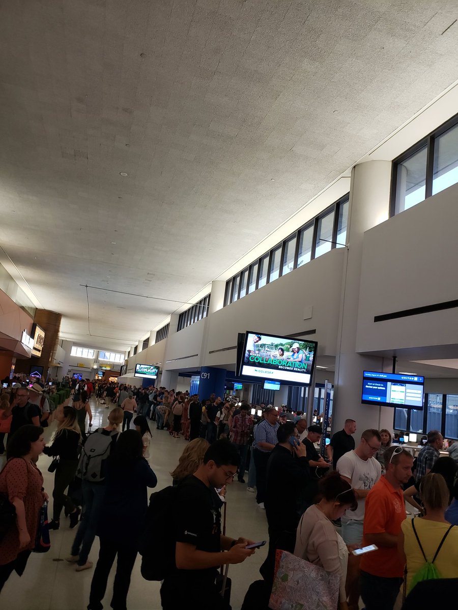 SandwickSays's tweet photo. @united this is a live view of the customer service line in Newark rn. Perhaps more than 3 people behind desks would be helpful? And to think I thought 15 people w/ 1 person behind a desk when you stranded me in YYZ yesterday was bad... https://t.co/bkvC70ru0Z