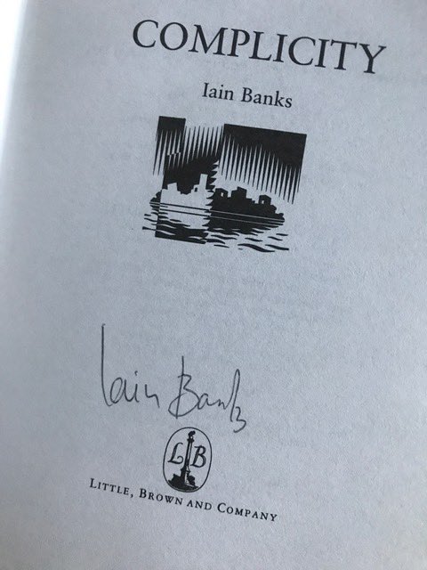 RMorrisWrites's tweet image. Came across this on my bookshelves today. Copy of Complicity signed by Iain Banks. I was first mesmerised by ’The Wasp Factory’ in 1984. Met up with Iain in an Edinburgh pub in 1988. He liked pubs and writing. Sadly missed. 
#IainBanks #TheWaspFactory #WalkingOnGlass #TheCrowRoad