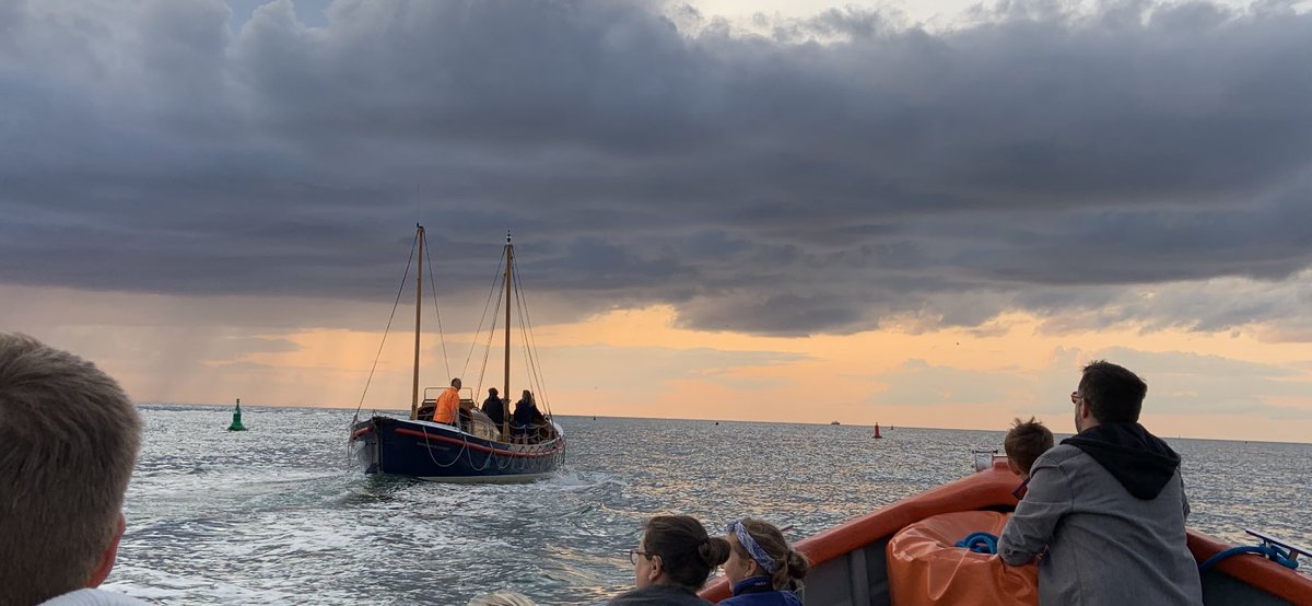 Two boats heading out to the sunset, the Wells Ferry and ex RNLI lifeboat  Lucy Lavers