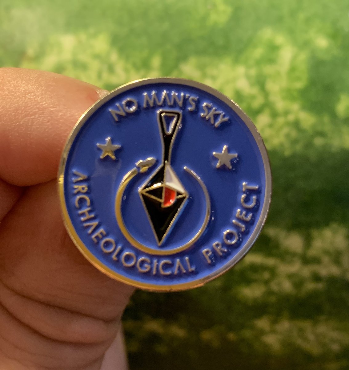 NMSarchaeology's tweet photo. The pin badges are here for the #NoMansSky Archaeological Project! 1-inch (2.54 cm) diameter metal. I’ll start shipping these to the indiegogo backers soon. My DMs are open if you would like to purchase one and help fund my data entry project. #NMSAS #Archaeogaming https://t.co/bZkqCTtYAl