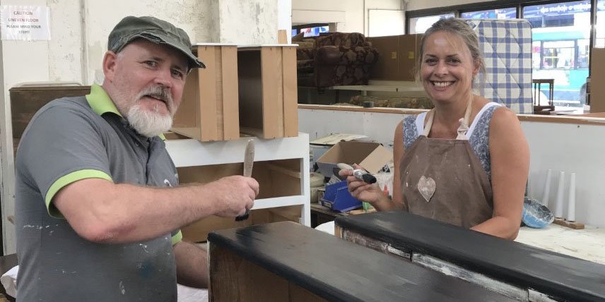 EmmausUK's tweet photo. A glimpse into how donated furniture is upcycled at @emmauscol. Companion Billy and volunteer Emma are prepping a chest of drawers for painting #Upcycling #Preloved #Reconditioned https://t.co/ZdHnGQdCfJ