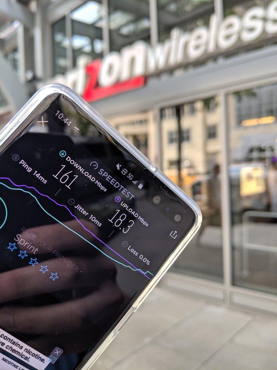 Speedtest.net app results in front of a Verizon store: 161 Mbps down, 18.3 Mbps up, 14 ms ping.