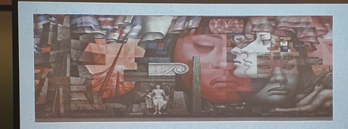 KesiMahendran's tweet photo. The painting by #GonzálesCamarena is called "Prescence of Latin America" the colonial invader occupies only a tiny portion. Red face symbolizes Latin America. Prof. Livia Simao explores shared myths & the creation of phantasms. #decolonization #decolonizingcurriculum #ISTP2019 https://t.co/pynbtkrLhJ
