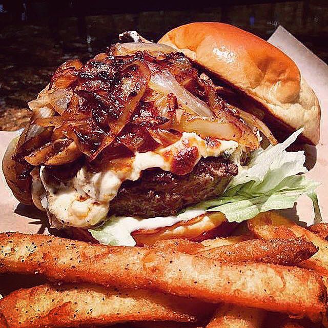 Up close with our Black &amp; Bleu Burger. Certified Angus Beef® blackened and loaded with caramelized onions, sautéed mushrooms, melted bleu cheese crumbles, lettuce and mayo. We open for lunch at 11:30! #johnnylukes #wilmingtonnc #ilmfood #ilm #portcityfoodies #goodeats