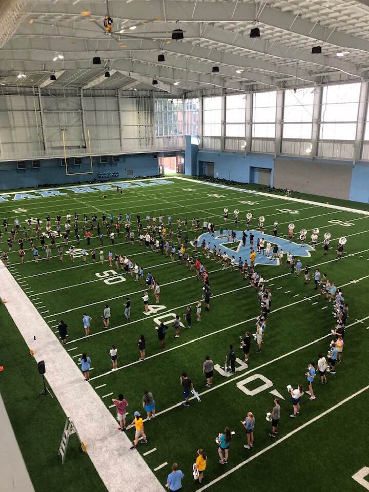 UNC_Bands's tweet photo. The whooooooole band lined up for warmups this evening. An awesome end to an awesome FDOC in the ~new~ indoor practice facility!! #bigthingscoming #POTACC https://t.co/wKS5hVZUId