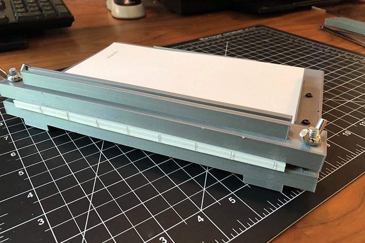 3D printed bookbinding jig, with a text block loaded in it