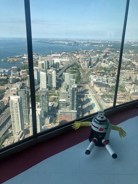 TourCNTower's tweet photo. Alex (@HitchbotWoods) wants to let his Grade 5 creators from Erin Woods School in Calgary know that he enjoyed his visit to the #CNTower! From high above Toronto, his next stop will take him under the sea. Stay tuned! https://t.co/bknUUMJTyf