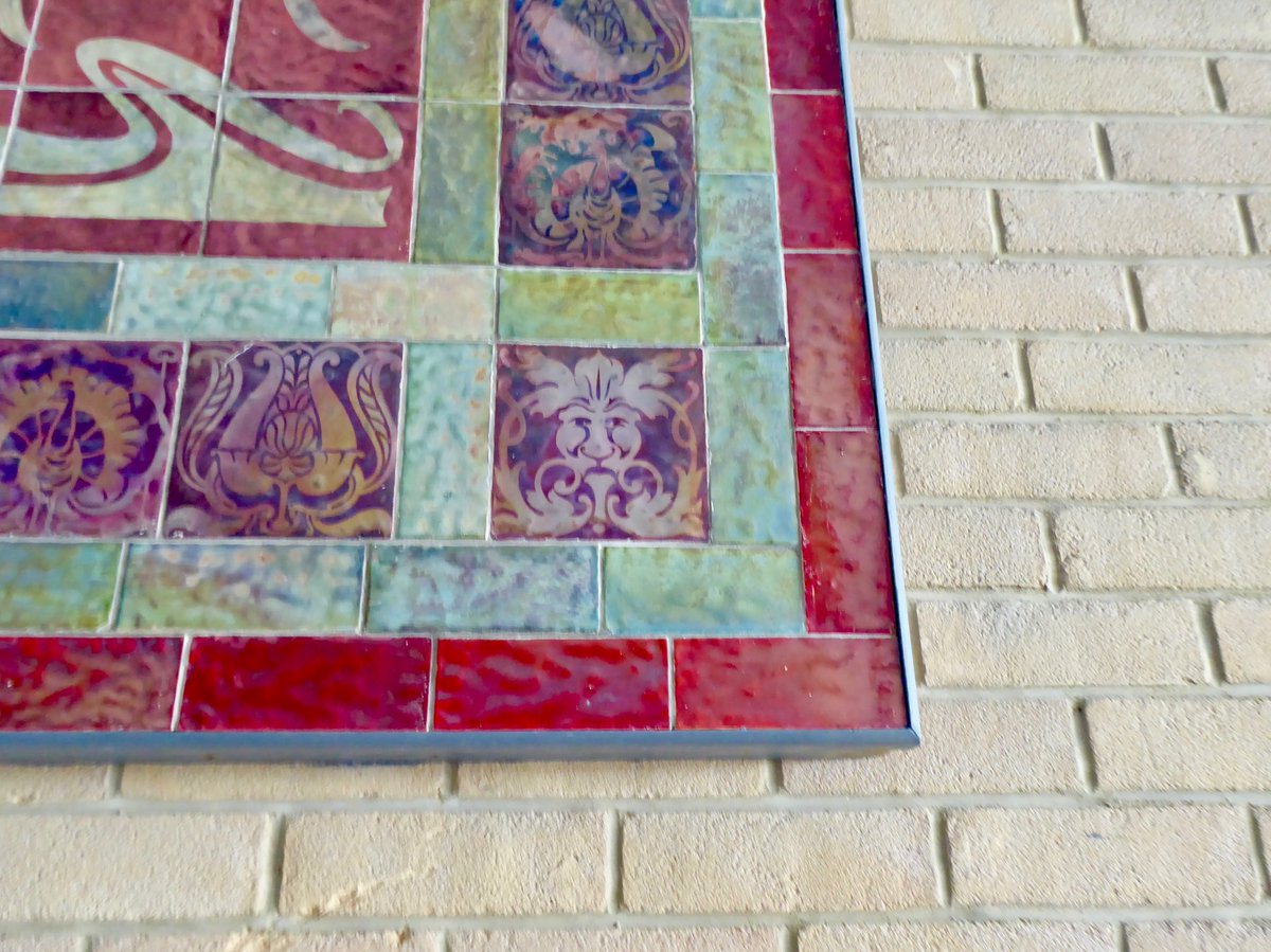 Portaspeciosa's tweet photo. A superb early C20 lustre wear plaque now rather lost on a wall in the half deserted Quay development in Poole; the site of the former Poole Pottery. In the corner there's a little foliate style head. https://t.co/HsZGGPCQ9t