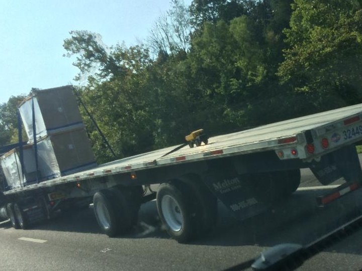dellis214's tweet photo. Yes, that is a #tonka truck strapped to a flatbed going up I-81 near Morristown. Big boys and their toys:) #funny #strangesights https://t.co/r8Q1qaiv2t