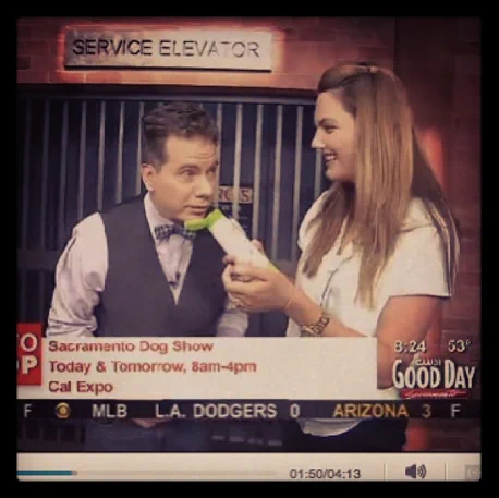 Woman holds a bottle on a television show.