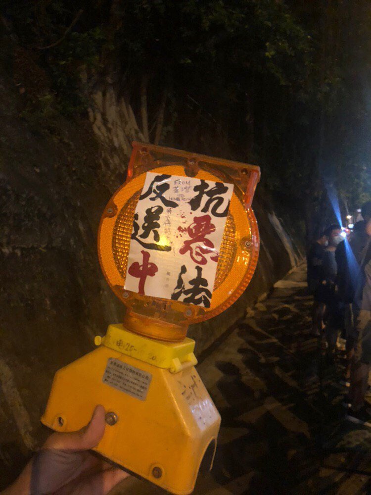 shelzhang's tweet photo. Ok this is fun. Protesters are doing a kind of relay where they’re passing objects along the human chain to different areas of Hong Kong. Each object says where it’s from and where it wants to go. Photos from various Telegram groups. https://t.co/fNbrf95OEe