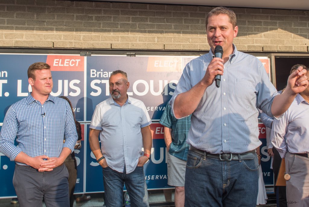 ottawabing's tweet photo. It’s time for Canadians to get ahead instead of barely getting by under Trudeau’s government, @AndrewScheer told a large cheering crowd in front of the newly opened campaign office of Brian St Louis, PC candidate for Nepean. #AndrewScheer @CPC_HQ @BrianForNepean @NepeanTories https://t.co/v7UU7n03yP
