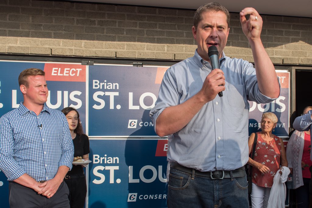 ottawabing's tweet photo. It’s time for Canadians to get ahead instead of barely getting by under Trudeau’s government, @AndrewScheer told a large cheering crowd in front of the newly opened campaign office of Brian St Louis, PC candidate for Nepean. #AndrewScheer @CPC_HQ @BrianForNepean @NepeanTories https://t.co/v7UU7n03yP