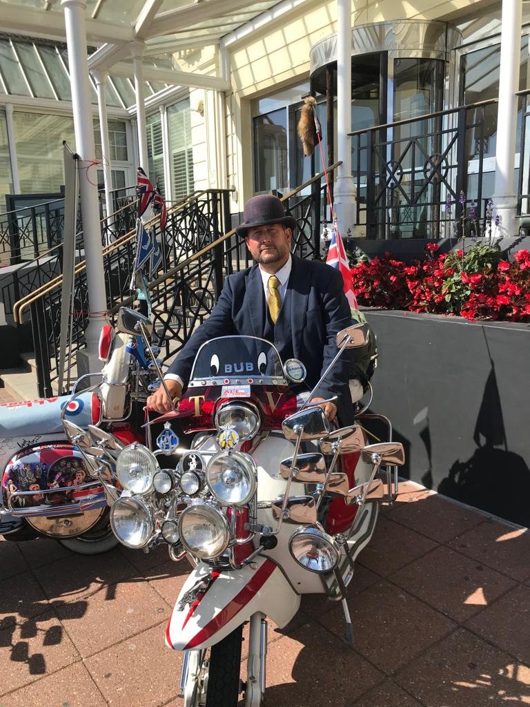 Our lovely Concierge team member Paul looking perfectly at home on this scooter and ready to welcome guests for the #ModWeekender and the <a href="/AONthemusical/">All Or Nothing: The Musical 🇬🇧</a> experience here at The Grand in sunny Brighton ☀️
