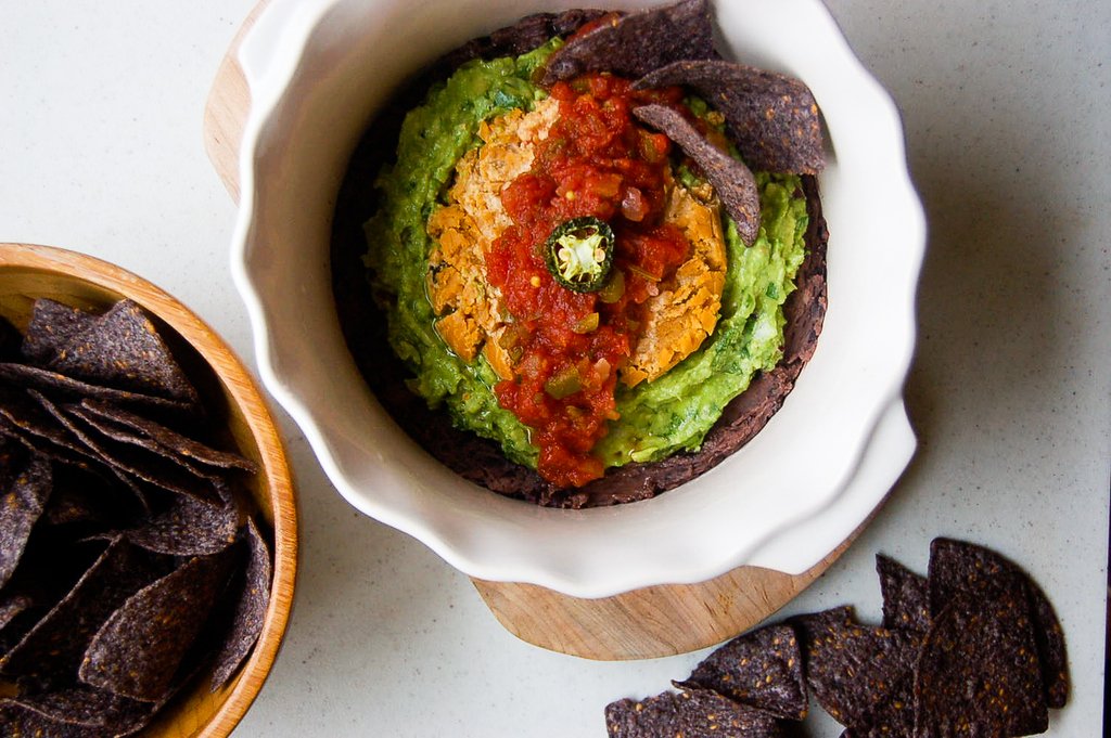 culcherd's tweet photo. Celebrate the weekend with this festive Mexican-inspired dip, which features layers of lime-spiked black beans, guacamole, our Sriracha Jalapeño cheese & fresh salsa. Recipe on our Facebook & Instagram! #howtouseculcherd#dairyfree #layerdip #vegansnack #itsnotdairy #plantbased https://t.co/iyP0kC4ru9
