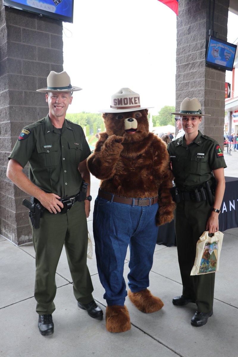 NYSDEC's tweet image. To celebrate #smokey bear’s 75th birthday, DEC Forest Rangers threw out the 1st pitch at the TriCity Valley Cats game. Local scouts cheered on. #smokeybear75
