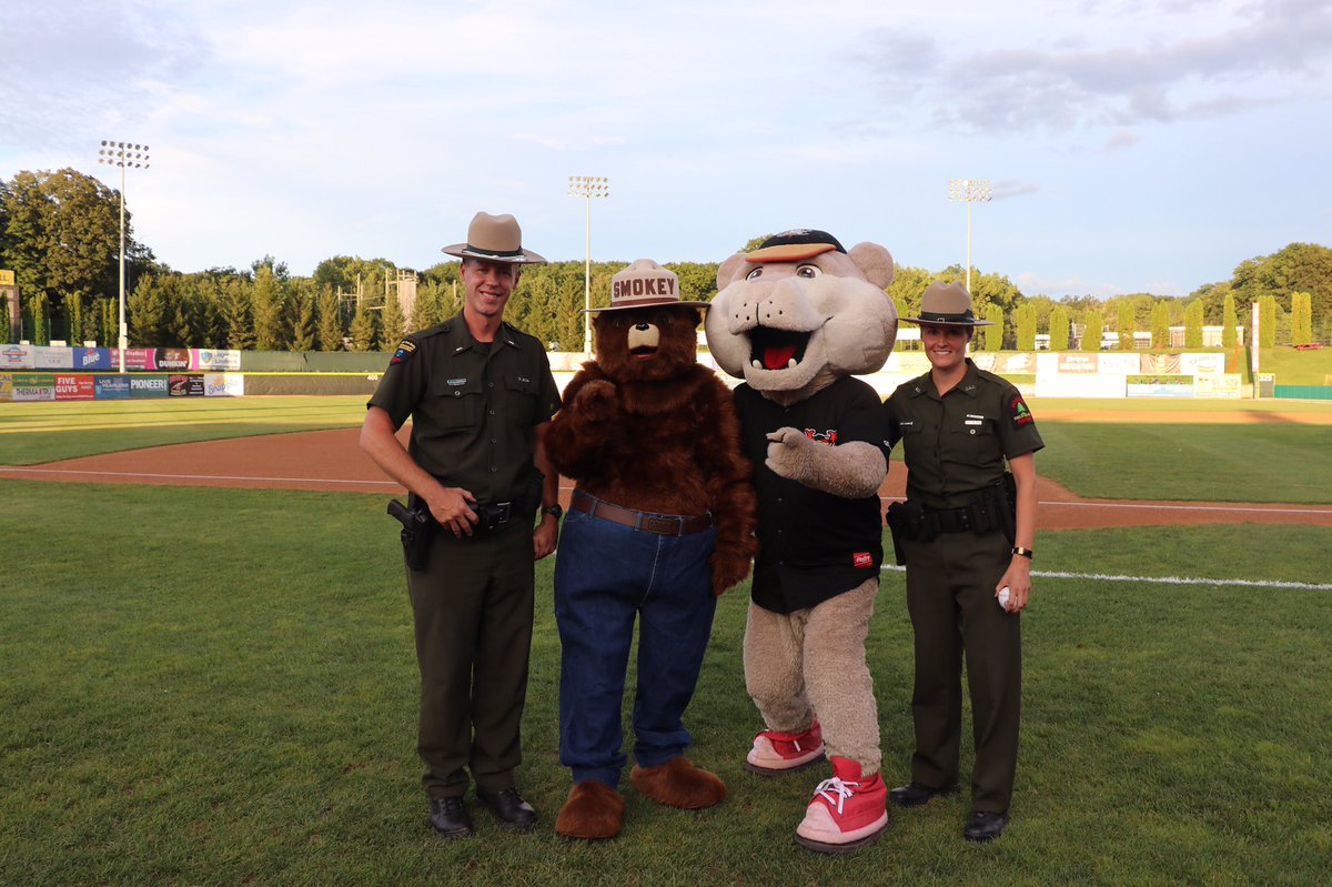 NYSDEC's tweet image. To celebrate #smokey bear’s 75th birthday, DEC Forest Rangers threw out the 1st pitch at the TriCity Valley Cats game. Local scouts cheered on. #smokeybear75